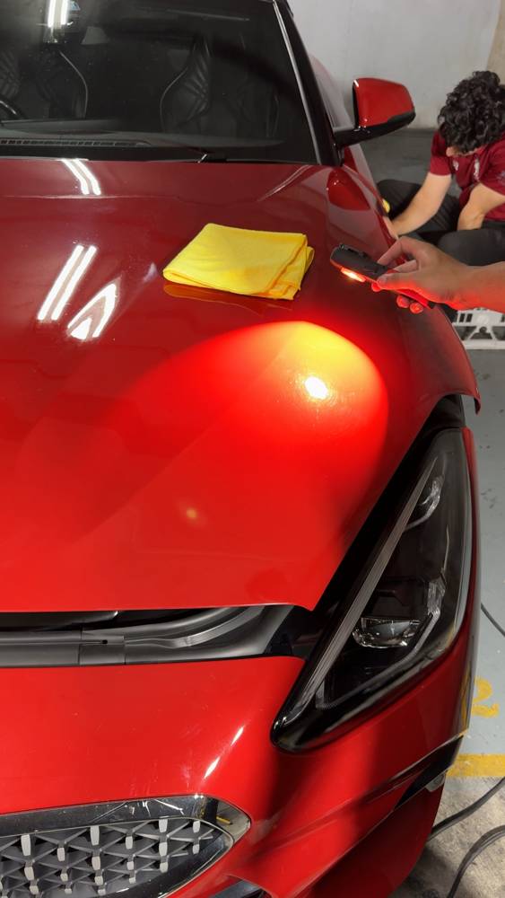 Checking red paint under an inspection light